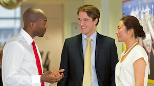 Three employees discussing work