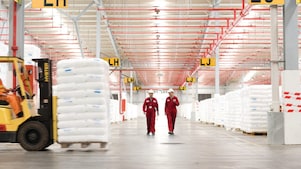 two employees walking in a factory