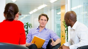 two employees interviewing a potential candidate