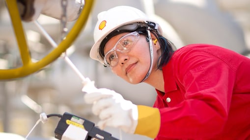 female employee inspecting equipment