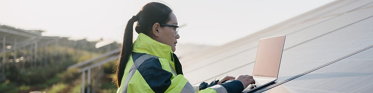 Female engineer repairing equipment at solar power station
