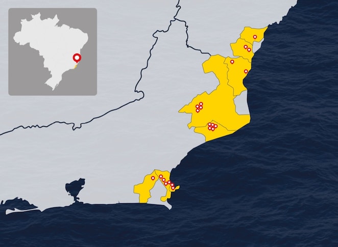 “Mapa da região sudeste do Brasil destacando áreas em amarelo nos estados do Rio de Janeiro e Espírito Santo, com marcadores indicando a localização de comunidades ao longo do litoral. No canto superior esquerdo, há um mapa menor do Brasil com destaque para a mesma região.”